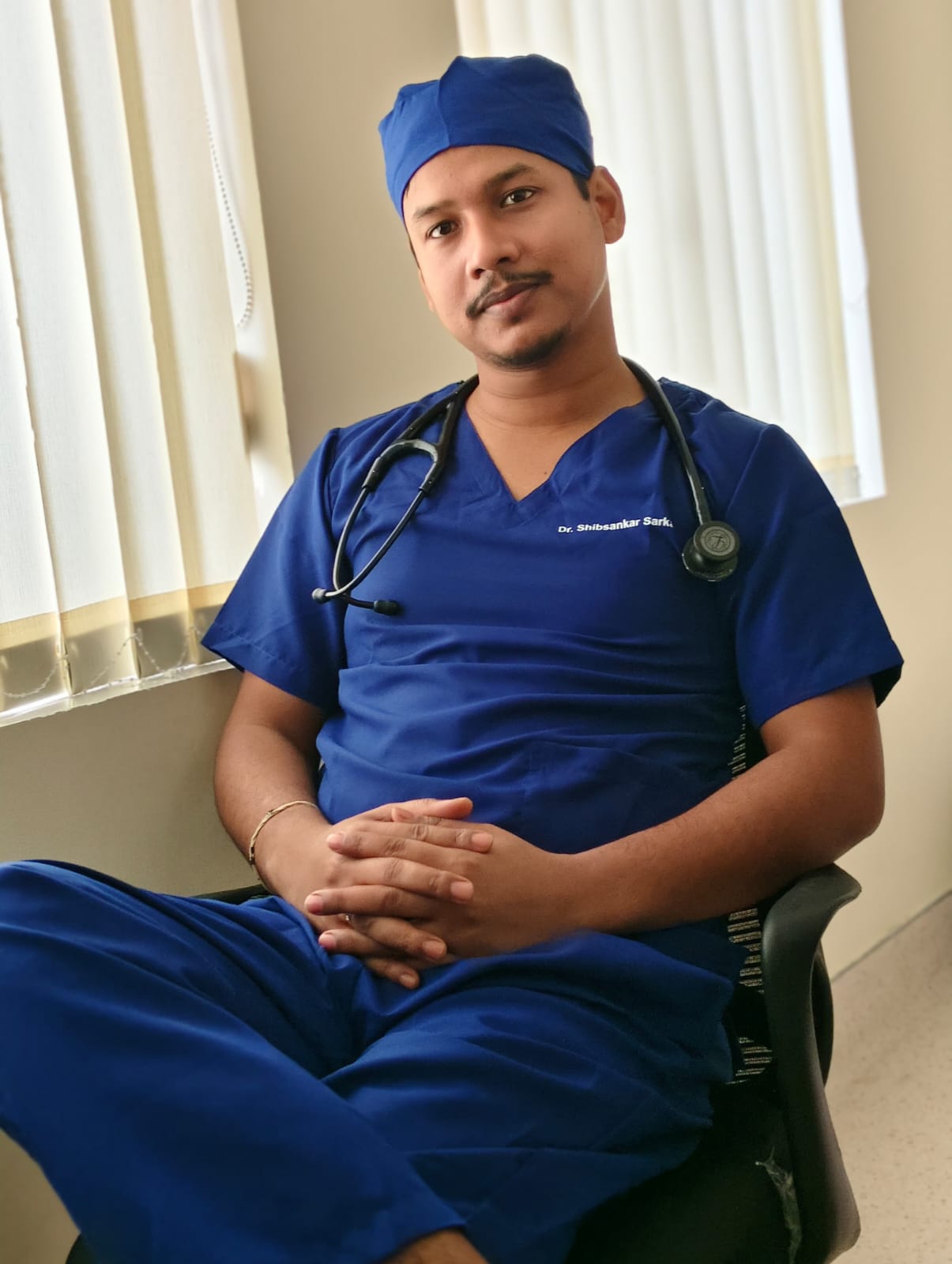 Dr. Shibsankar Sarkar in clinical attire